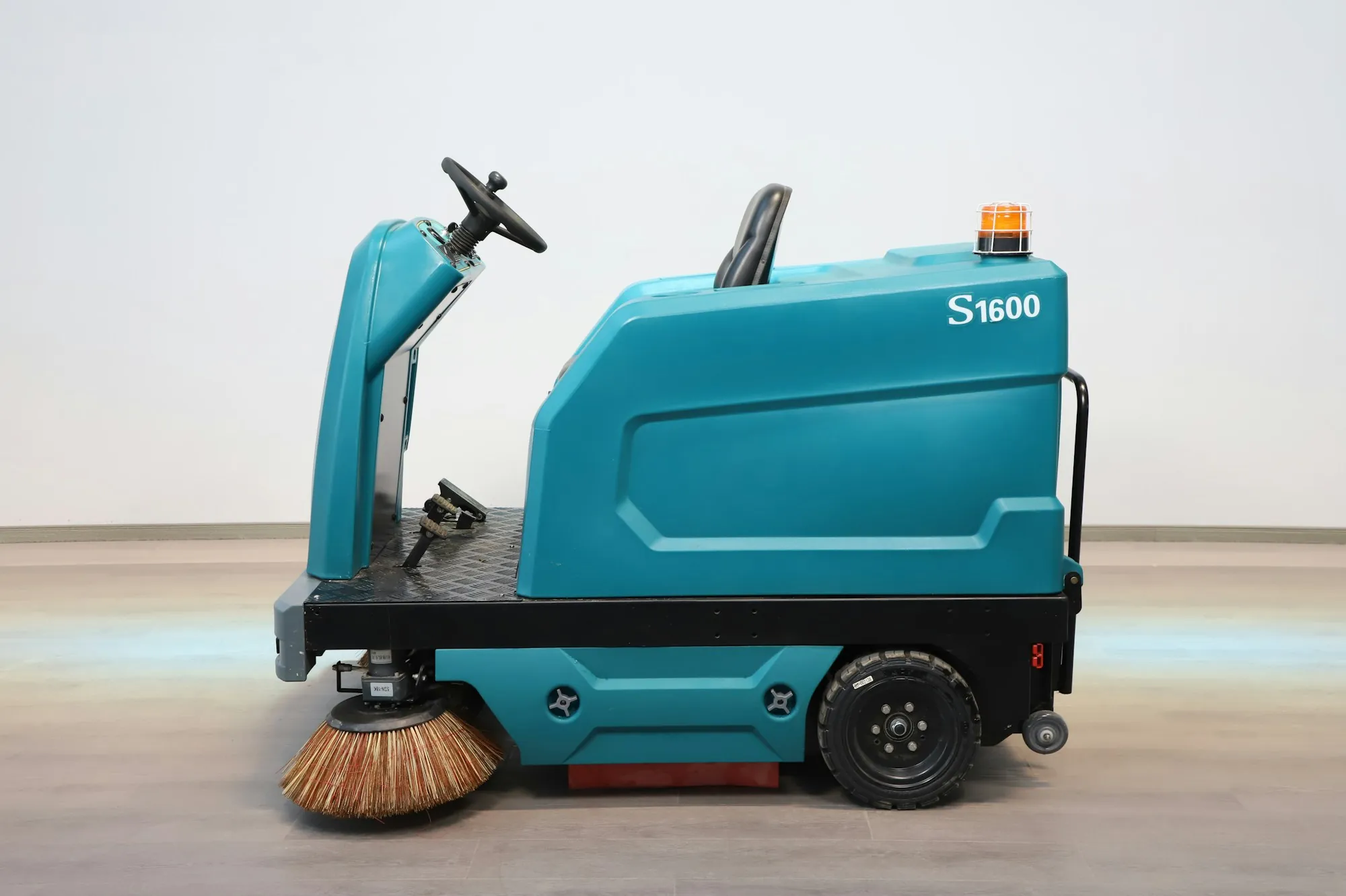 Ride-on commercial floor sweeper on a smooth floor