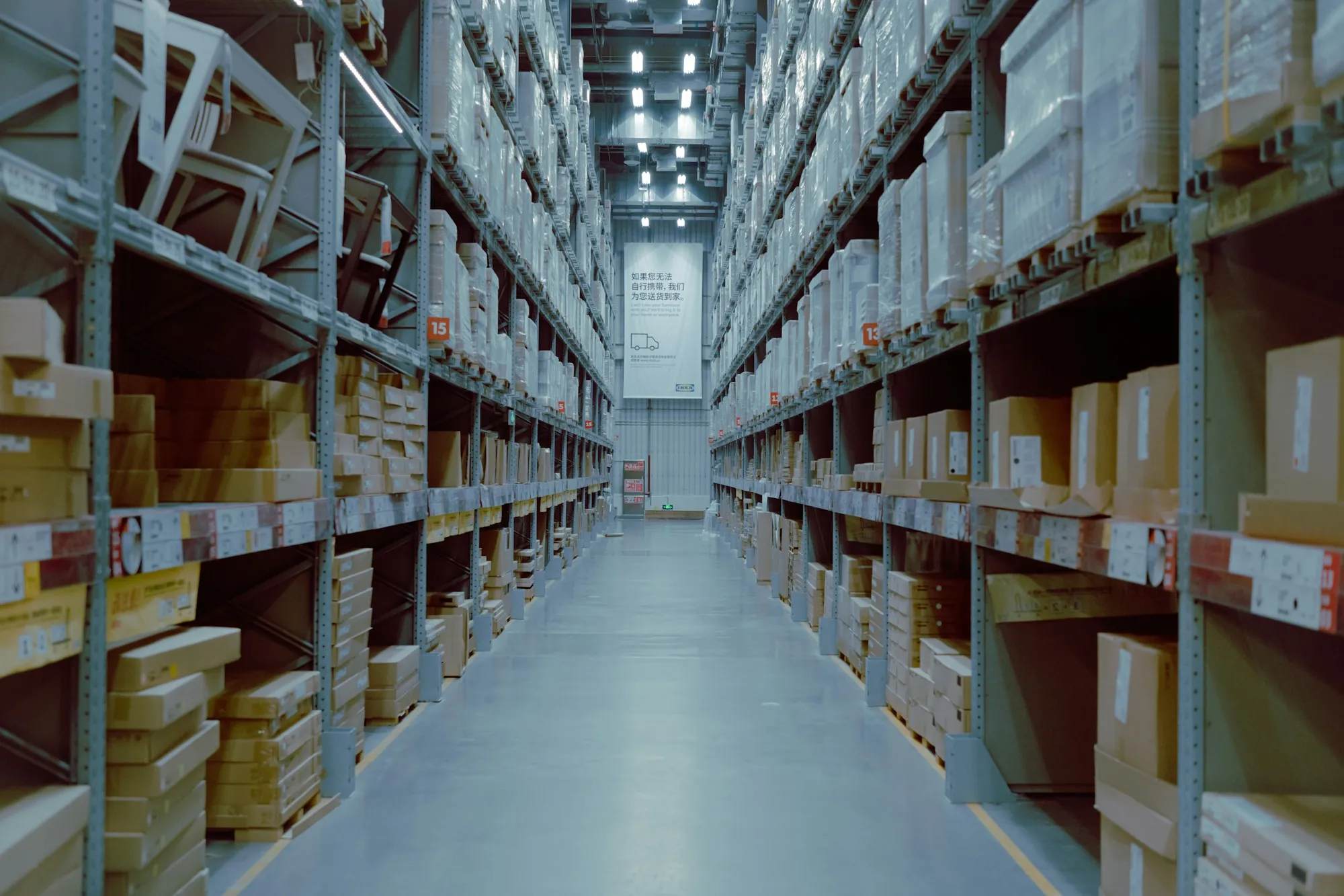 Warehouse aisle lined with stocked shelving